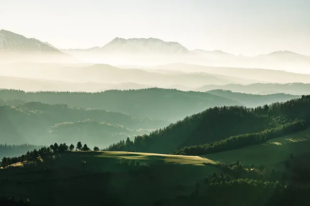 Layers of green hills veiled in mist.