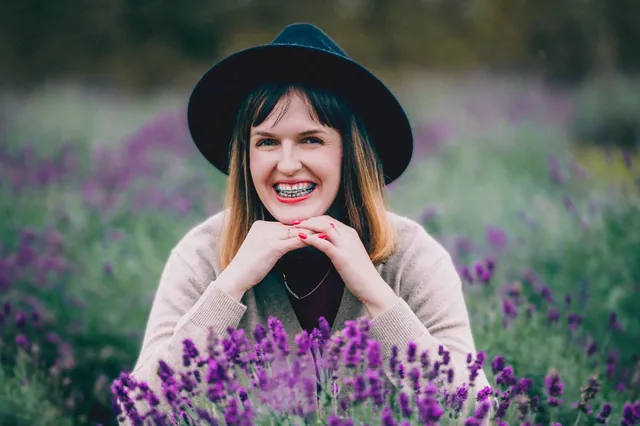 Smiling portrait among purple flowers.