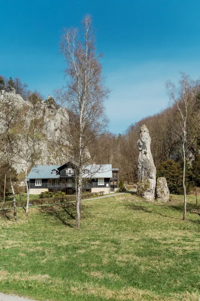 Pale cliffs and buildings in a green valley.